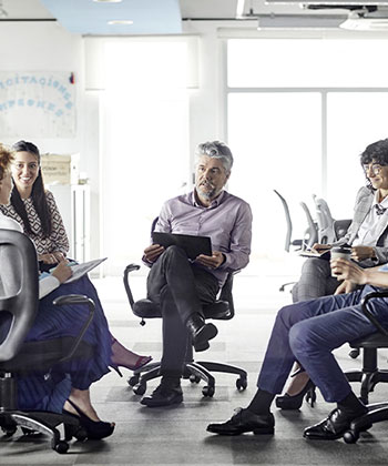 Man with tablet in a group setting
