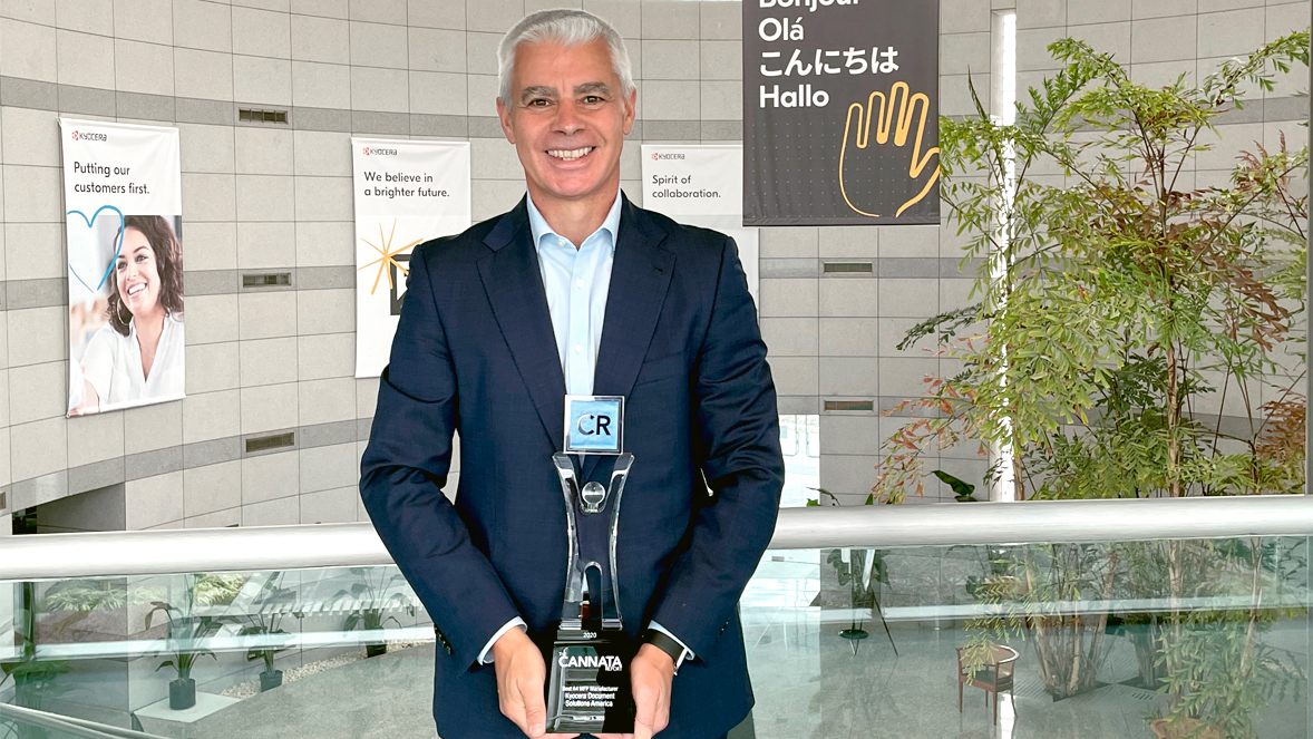 Kyocera Document Solutions America President Oscar Sanchez holding award Kyocera Document Solutions America President Oscar Sanchez holding award